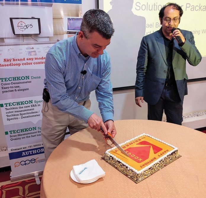 Michael Bialko of Kodak cutting the cake. Photo PSA