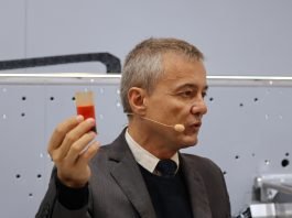 Federico D'Annunzio, product owner, Hybrid & Label Printing, Bobst, explaining that the ink-on-demand which was shown on another innovative Bobst label press is an optional extra for DigiFlexo print units that replaces conventional inking reservoirs with a single rubber pipe that dispenses 30 grams of ink to the print unit. Photo PSA