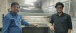 Kailash Jajoo, chief executive officer, All Time Offset Printers (Left) and his son Sargam Jajoo (Right) standing in front of his RMGT press