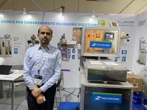 Parag Patwardhan, vice-president of Sales and Marketing at Nichrome displays Athena MAP (modified atmosphere packaging) food tray sealing packaging machine at PackPlus 2022. Photo: PSA