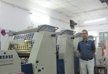 Nand Kishor Singh, director at Megalith PrintCare, standing with a 4-color Adast Dominant 745 C offset printing machine. Photo: PSA