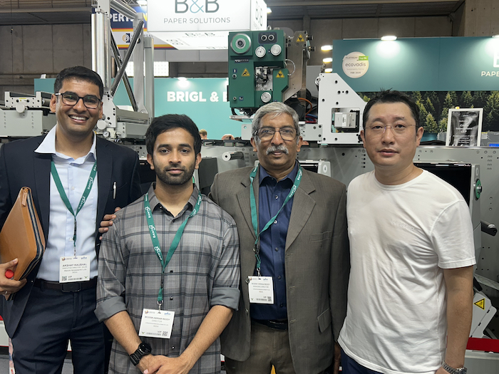 L–R Akshay Kaushal of Provin Technos, Chenga Reddy and Abhiman Reddy of Citrus, and Kevin Ren of Spande in front of the S7 8-color press demonstrated at Labelexpo Barcelona that will be shipped to Hyderabad for installation at the Citrus Innovation plant Photo PSA