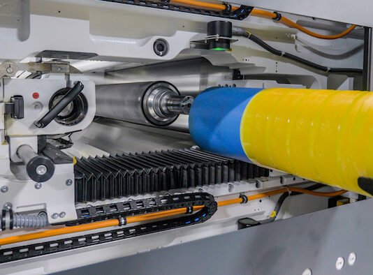 Flexcel Prime plate on a sleeve being inserted into the press Photo Miraclon