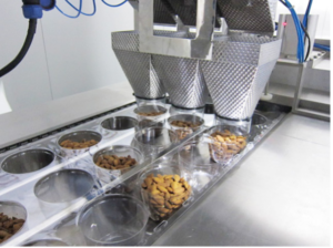 Customized line for nut packaging with deep forming enhanced with a multihead weigher for fast distribution into each cavity  Photo Utien Pack