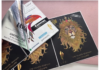 In this image, the monochrome variable print visible on the peeled‑back foil adhesive layer was produced by the K600i; the full‑colour front of the label (featuring the lion) was printed on the N730i.
