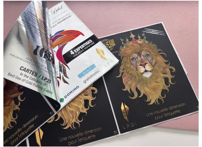 In this image, the monochrome variable print visible on the peeled‑back foil adhesive layer was produced by the K600i; the full‑colour front of the label (featuring the lion) was printed on the N730i.